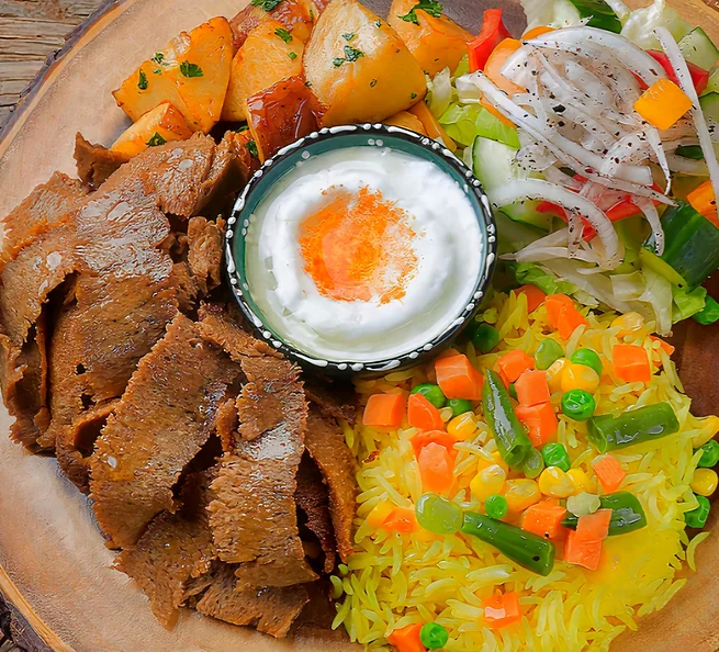 Beef donair with rice, garlic potatoes, salad and garlic sauce