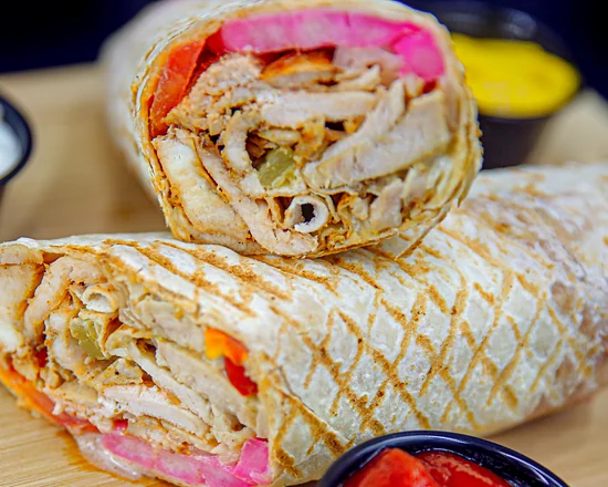Chicken shawarma wrap cut in half, showing the chicken filling